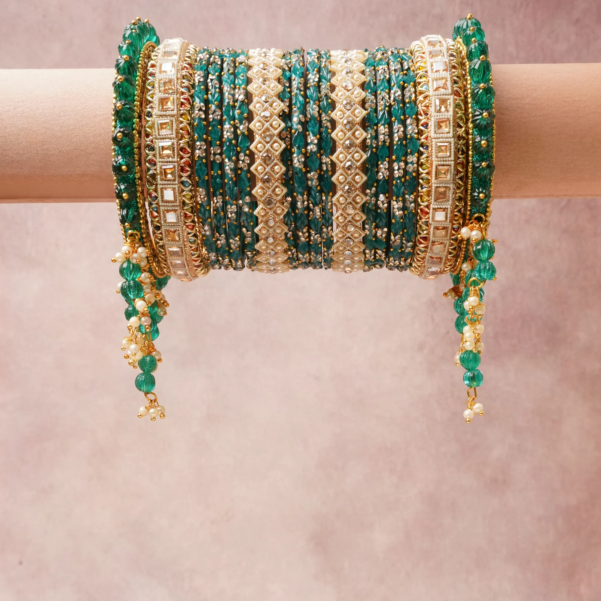 A commanding Emerald Green anchors this beautiful set, enriched with accents of Gold, Cream, Clear that add depth and dimension.

Featuring a striking composition of Gold-toned Metal, Glass, Pearls, Kundan-style Glass Stones, this set carries intricate craftsmanship and strong presence. Grand in form, it is created for moments that deserve to be marked.